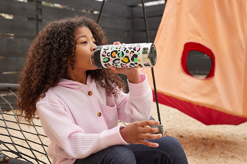 Girl drinking from leopard print water bottle